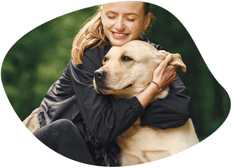 woman hugging her labrador dog